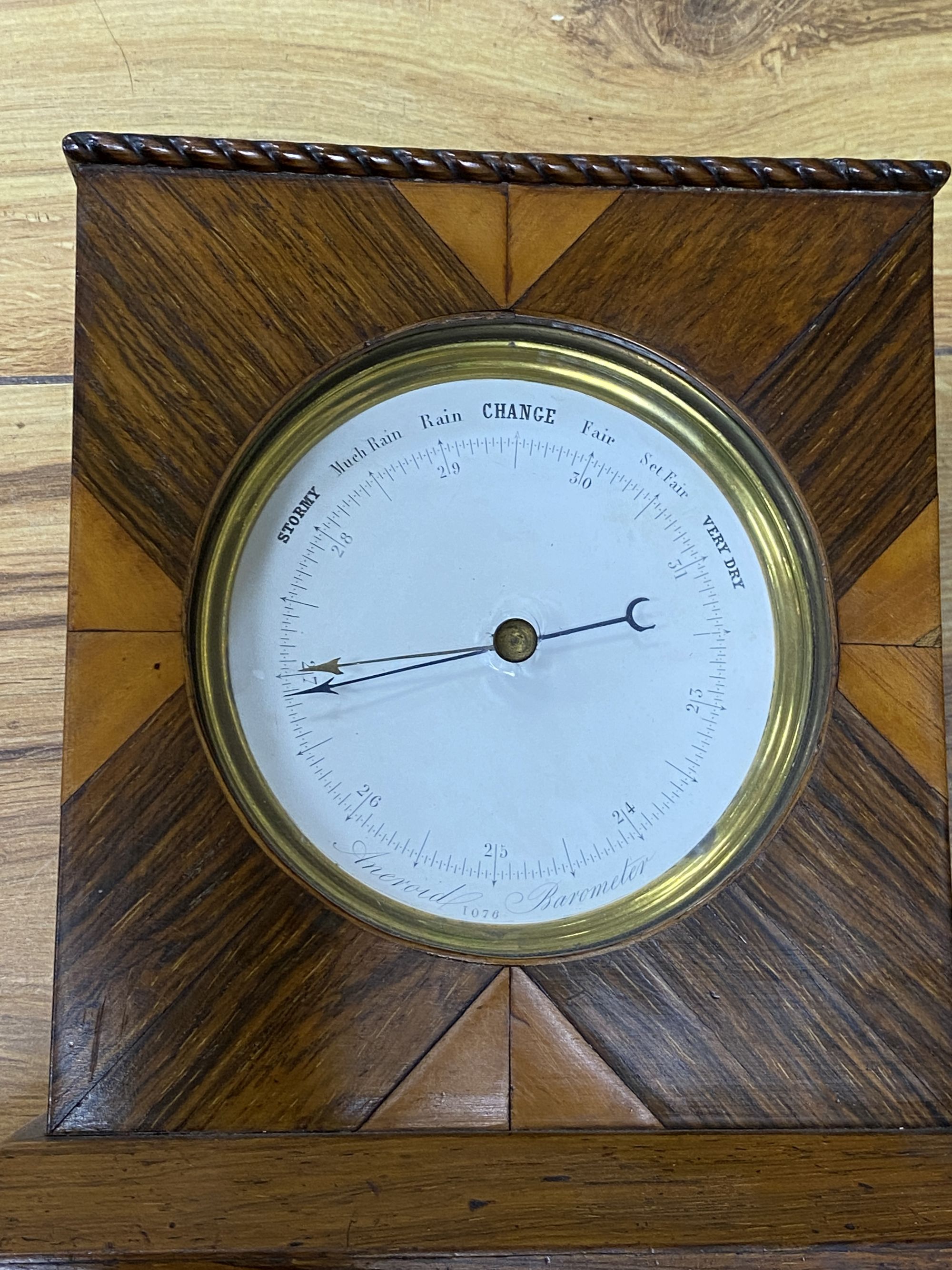 A Victorian silver mounted cane, a wheel barometer and a mantel barometer